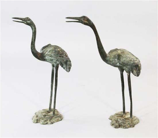 A pair of patinated bronze cranes, tallest 27.5in.